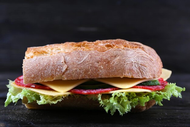 Foto sanduíches frescos e saborosos com queijo e legumes em fundo de madeira