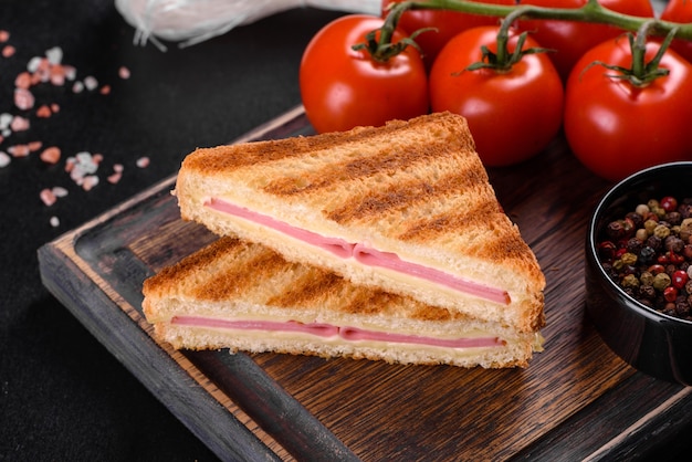 Sandwich mit Schinken, Käse, Tomaten, Salat und Toastbrot