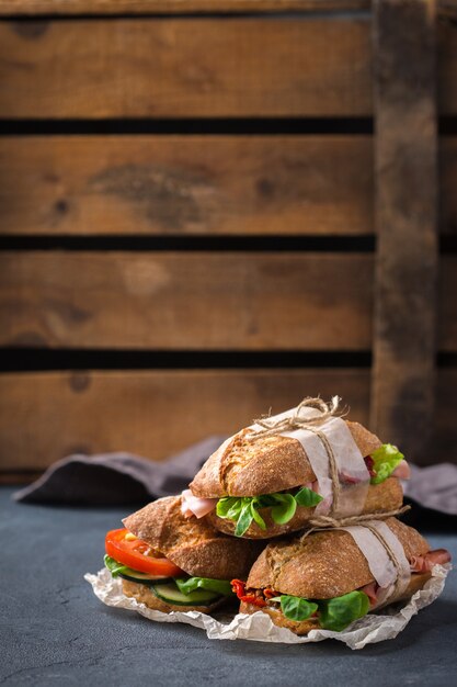 Sándwich de pan de centeno fresco con jamón lechuga y tomate