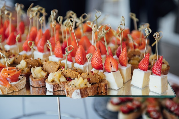 Foto sandwiches, häppchen und kuchen auf dem festlichen tisch. eine große auswahl an snacks. einschließlich für veganer