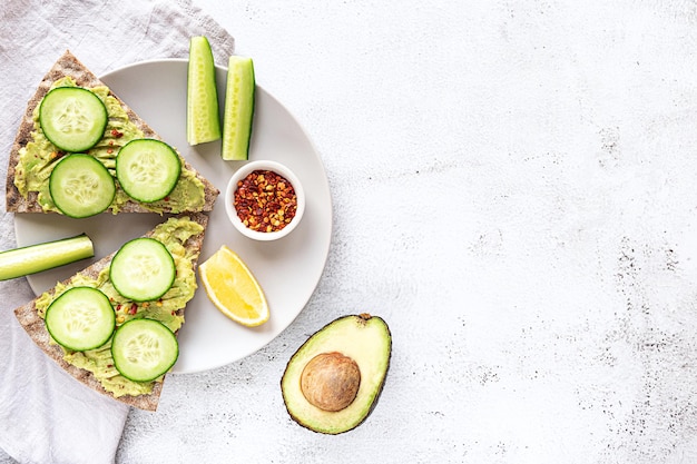 Sándwiches de pan crujiente con puré de aguacate y pepino