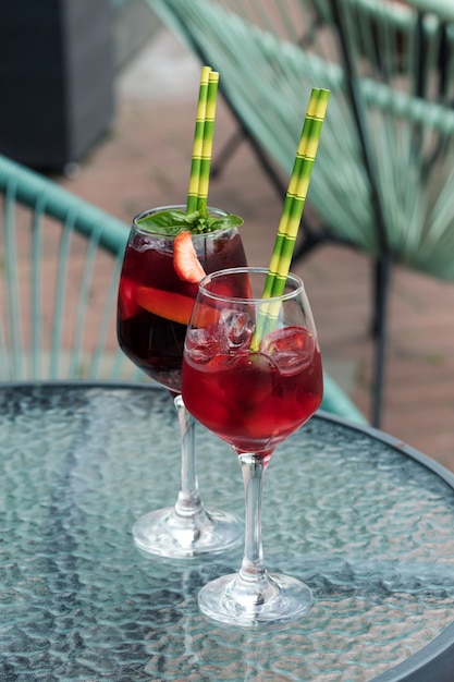 Foto sangria in glas und gläsern mit erdbeeren und orangen.