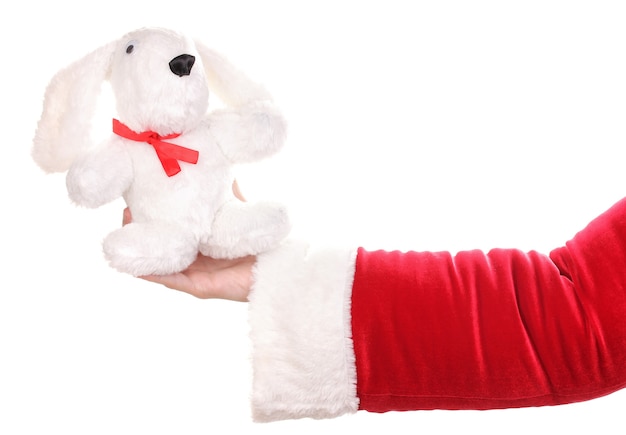 Santa Claus Hand hält Spielzeugkaninchen isoliert auf weiß