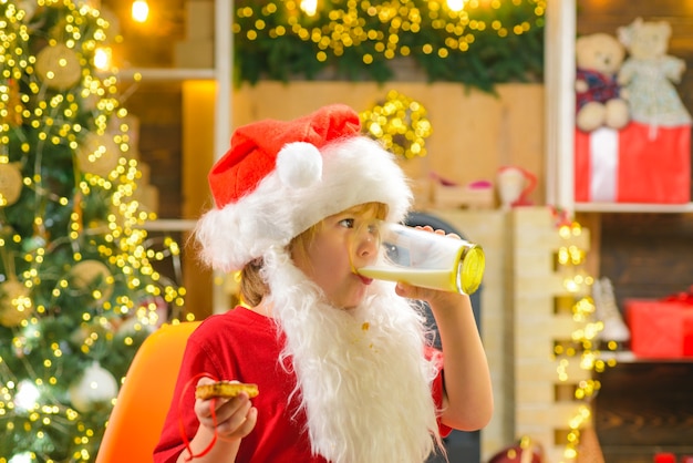 Santa con galleta y vaso de leche en el árbol de Navidad