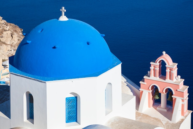 Foto santorini, grecia. iglesia de arquitectura tradicional en el pueblo de oia, símbolo de las islas griegas, mar egeo.