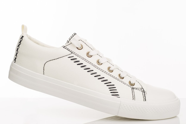 Sapatos de caminhada brancos na moda sobre um fundo branco. - imagem