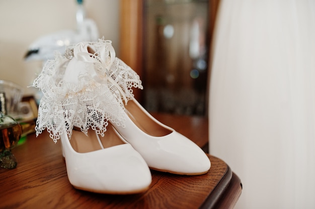 Sapatos de casamento branco elegante na manhã da noiva.