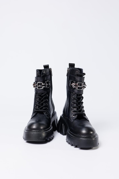 Sapatos femininos em um fundo branco Closeup de botas de couro preto feminino com fivelas em um fundo branco Sapatos para a cidade Conceito de design de moda e calçados 2022