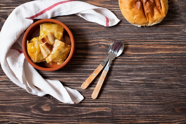 Sarma - plato tradicional de la cocina balcánica. Rollitos de col con carne y arroz. Cocina balcánica. Cocina serbia. Fondo de madera oscura Vista superior. Espacio para texto