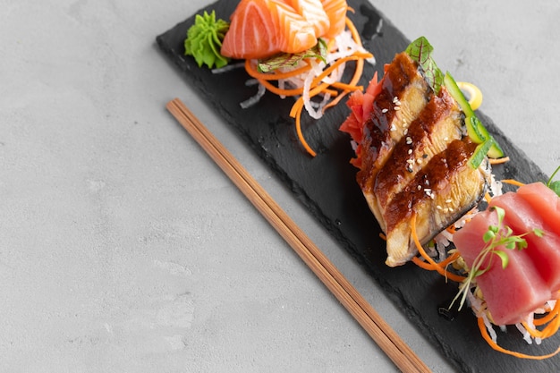 Sashimi de sushi de salmão, enguia e atum servido no prato