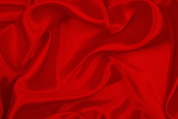 Foto satén lujoso de la textura de seda roja para el fondo abstracto