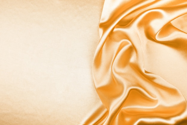 Satin-Zusammenfassungshintergrund der goldenen silk Beschaffenheit luxuriöser, Gewebe