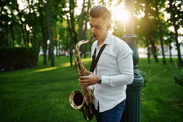 Saxophonist spielt Melodie im Sommerpark