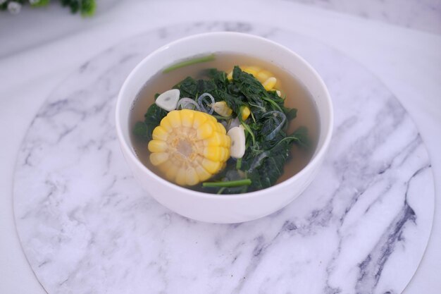 Foto sayur bening daun kelor jagung o sopa clara de moringa oleifera con maíz dulce servida en un cuenco