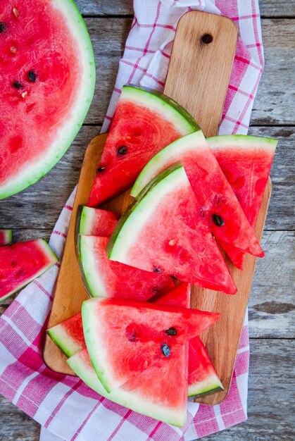 Scheiben frischer saftiger Bio-Wassermelone auf Holzhintergrund