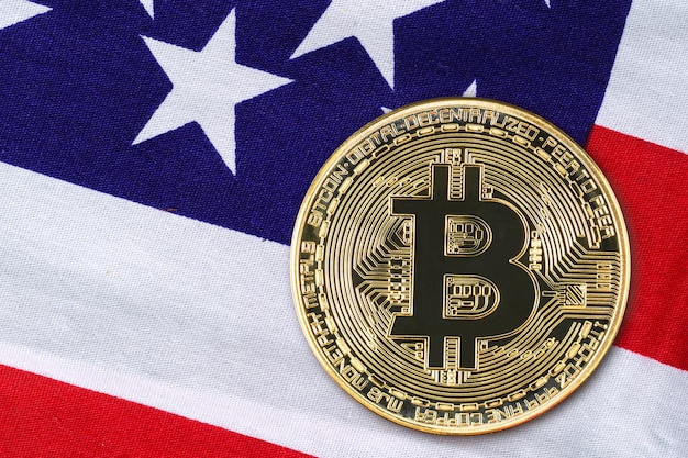 Schließen Sie herauf Gold-Bitcoin-Münze auf usa-Flagge