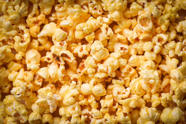 Schließen Sie herauf Popcorn - Draufsicht des süßen Butterpopcornbeschaffenheitshintergrundes