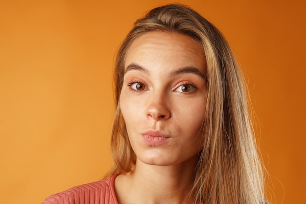 Schließen Sie herauf Porträt einer netten jungen Frau mit langen blonden Haaren.