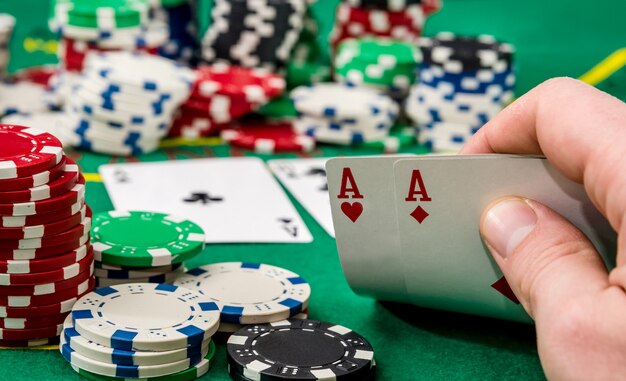 Schließen Sie oben von einem Pokerspieler, der Spielkarten hält