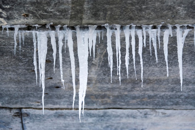 Schmutzige Betonstruktur mit Eiszapfen