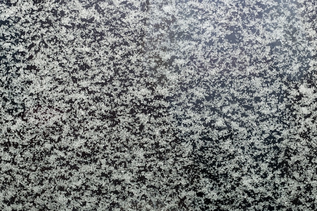 Foto schneebeschaffenheit, schneeflocken auf dem glas. winter abstrakten hintergrund.