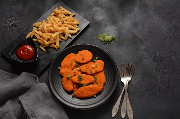 Schnitzel de frango ou nuggets com batatas fritas e ketchup