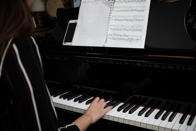 Schöne asiatische Mädchen lernen, Klavier zu spielen