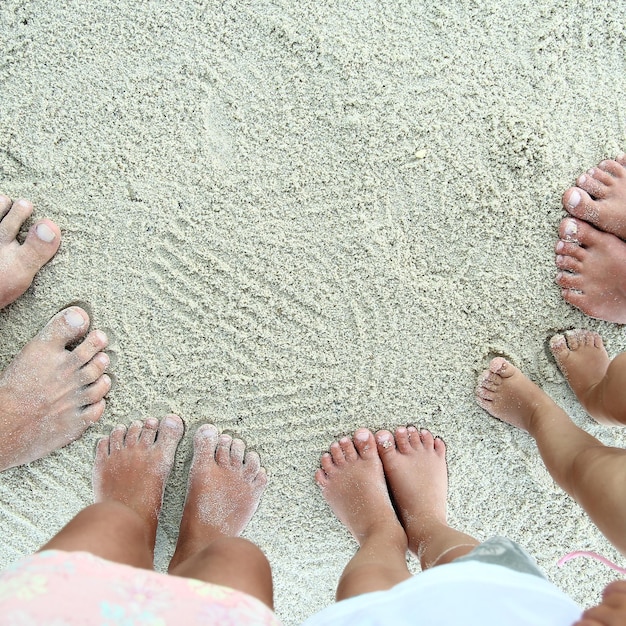 Schöne Beine im Sand am Meer