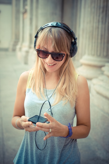 schöne blonde Frau, die Musik hört