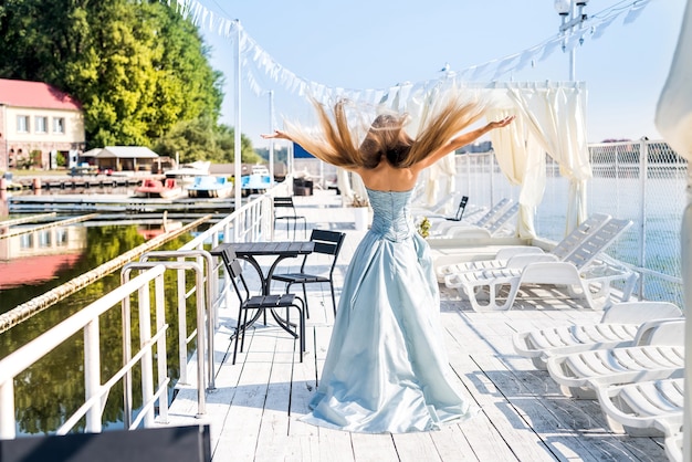 Schöne Frau am Strand und posiert im Minzkleid