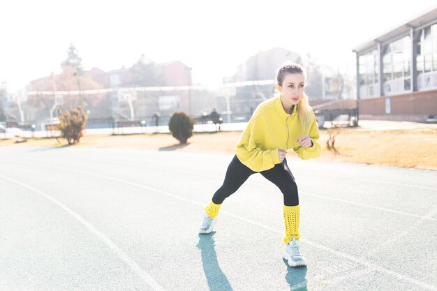 Schöne Frau, die sich vor dem Training ausdehnt