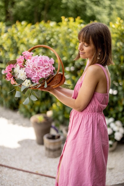 Schöne Frau mit Blumen im Garten