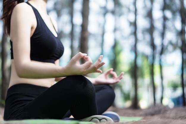 Schöne Frau übt Yoga im Park