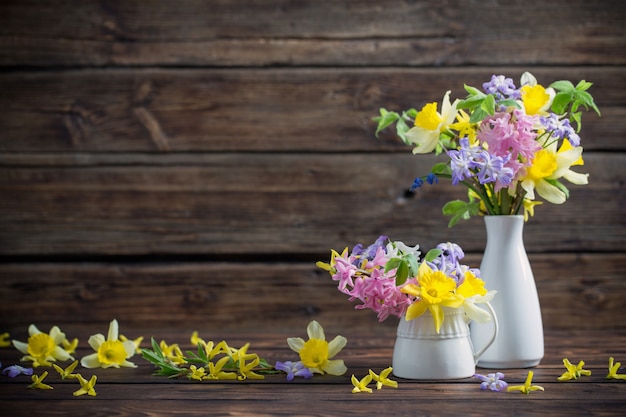 Schöne Frühlingsblumen auf dunklem altem hölzernem Hintergrund