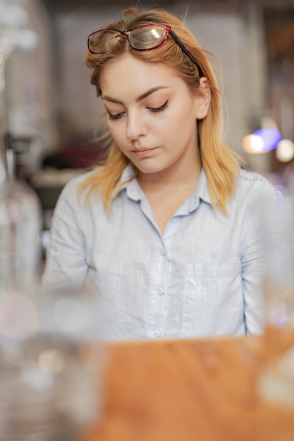 Schöne junge Frau, die an der Bar trinkt