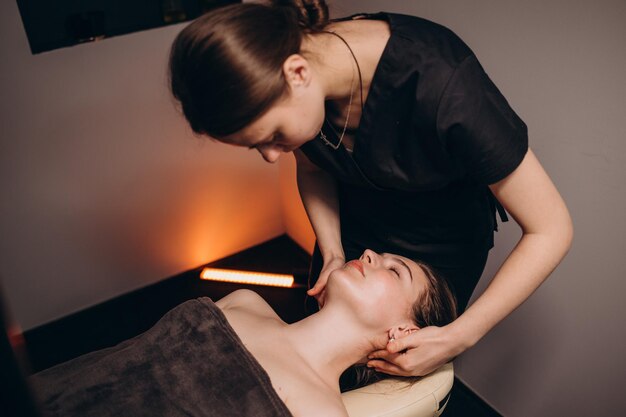 Schöne junge Frau, die Massage im Spa-Salon genießt?