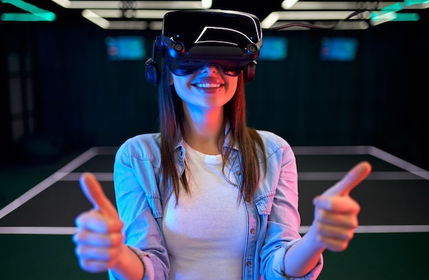 Schöne junge Frau mit Brille virtueller Realität. VR, Spiele, Unterhaltung, zukünftiges Technologiekonzept.