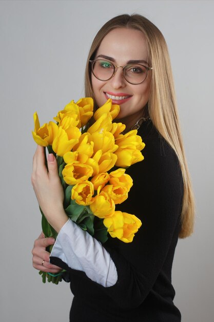 Schöne junge Frau mit Tulpen