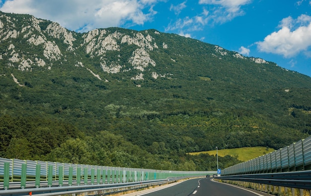 Schöne malerische Landschaft auf mit Wäldern bedeckten Bergen Blick aus dem Autofenster auf eine moderne und hochwertige Autobahn