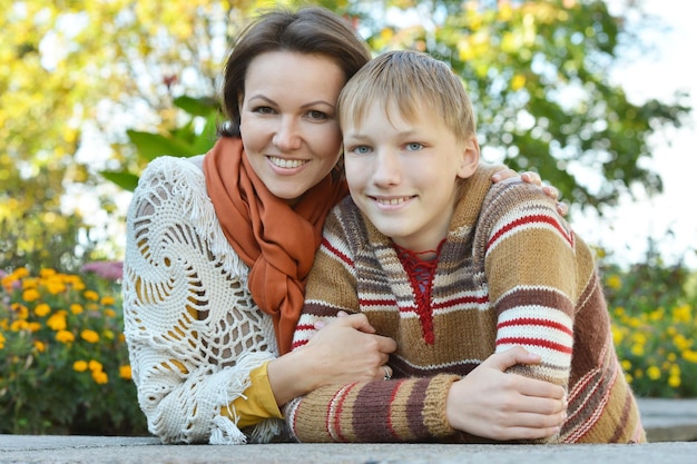 Schöne Mutter mit Sohn im Herbstpark