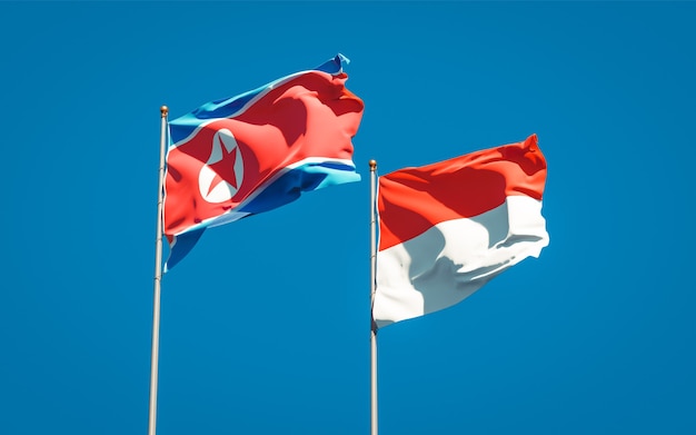 Schöne Nationalstaatsflaggen von Nordkorea und Indonesien zusammen auf blauem Himmel