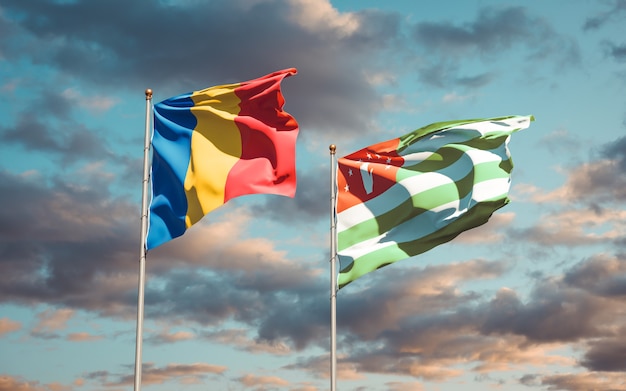 Schöne Nationalstaatsflaggen von Rumänien und Abchasien zusammen auf blauem Himmel. 3D-Grafik