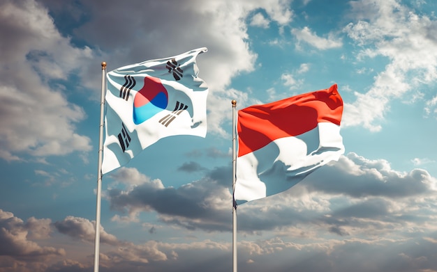 Schöne Nationalstaatsflaggen von Südkorea und von Indonesien zusammen auf blauem Himmel