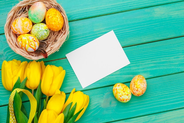 Schöne Ostern-Zusammensetzung mit verzierten Eiern und Blumen