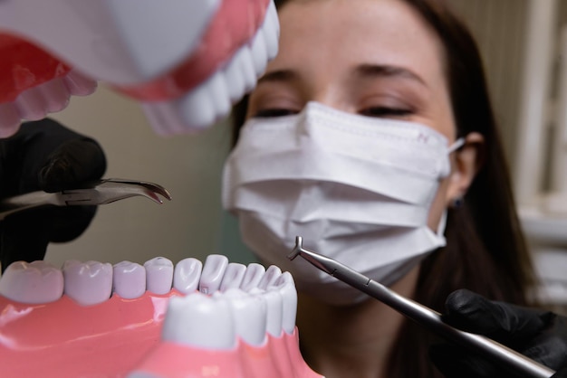 schöne Ärztin mit zahnmedizinischer Ausrüstung in der Zahnheilkunde