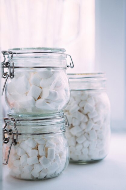 Foto schöne weiße marshmallow in einem glasgläschen marshmellous in einem glasschüssel auf weißem hintergrund