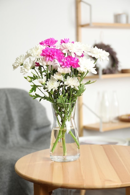 Schöner Blumenstrauß aus Chrysanthemen auf Holztisch im Innenbereich Innenarchitektur
