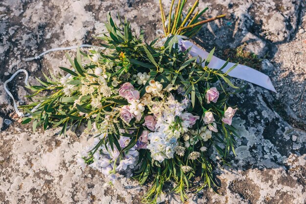 Schöner Blumenstrauß liegt auf dem felsigen Boden Hochzeitskonzept