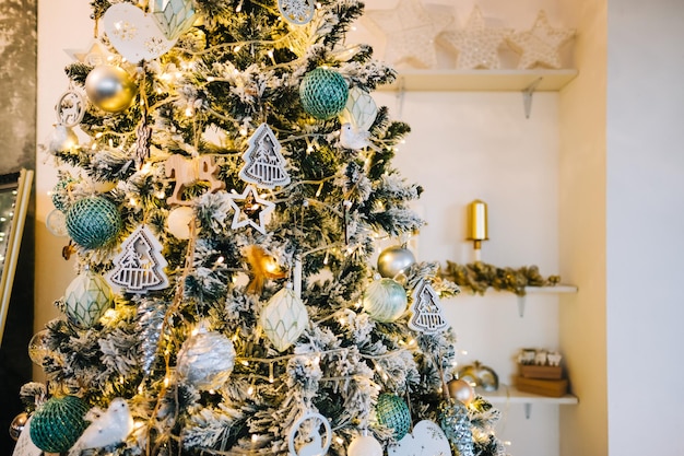 Foto schöner weihnachtsbaum mit girlande und spielzeug in der nacht zu hause.