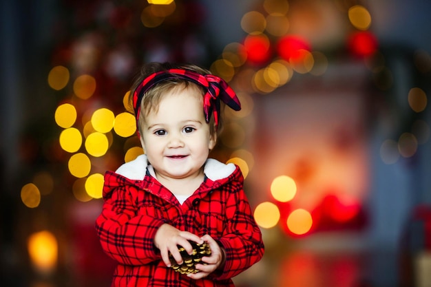 Schönes Baby an Silvester inmitten leuchtender festlicher Lichter